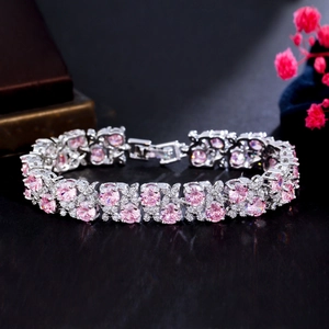 Macro view of silver bracelet featuring pink round gemstones and brilliant white diamonds