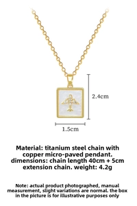 Macro detail of gold square shell pendant with airplane design and full crystal inlay