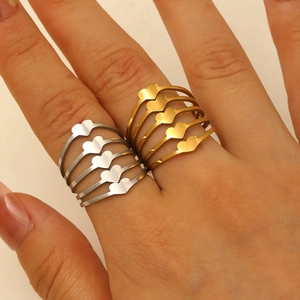 Detail of stacked five-layer heart rings in polished silver and gold stainless steel finish