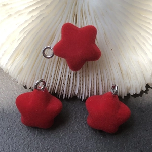 Detail of red flocked star pendant with metal loop for DIY keychain and jewelry making
