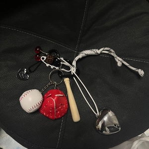 Detail of mini baseball keychain set with leather glove, wooden bat and heart charms