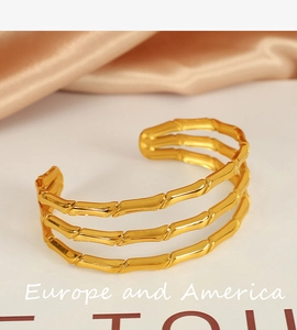 Detailed close-up of 18k gold plated triple-layer bamboo style open cuff bracelet