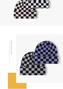 Detail of four checkerboard knit beanies in various colors with folded cuff design