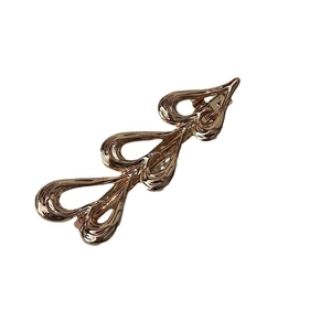 Elegant rose gold metal bow hair clip with polished hollow design on white background