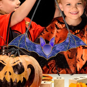 Detail of bat-shaped stained glass halloween hanging decor with purple metal chain