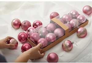 Pink Christmas ball ornaments set with matte, glossy, and glitter finishes in kraft boxes
