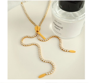 Macro view of gold-plated zipper chain necklace with pavé cubic zirconia settings