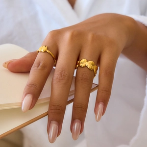 Minimalist gold heart ring set featuring a polished open design for women, shown on hand