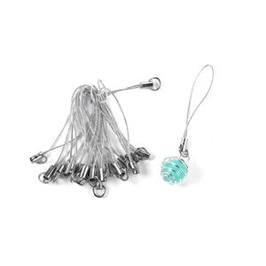 Macro view of silver DIY lanyards with a green bead in a spiral metal cage charm