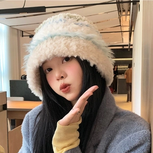 Detailed texture of thick plush knit bucket hat in striped blue and white for winter