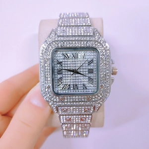 Detailed close-up of a silver square watch featuring full crystal inlay and Roman numerals
