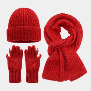 Detailed view of red knitted winter set featuring beanie, scarf, and touch-screen gloves