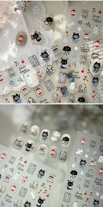 Detail of cartoon nail stickers featuring black cats and coffee cups on white lace background