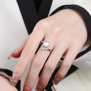 Elegant rotating silver ring for women with white stone inlay and pave set cubic zirconia