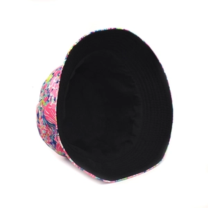 Detail of floral print bucket hat showing reversible black lining and summer pattern