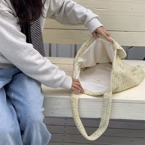 Detail of the large plush tote bag showing the spacious interior and zipper pocket