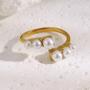 Detail shot of 18K gold plated stainless steel open ring with symmetric white pearls