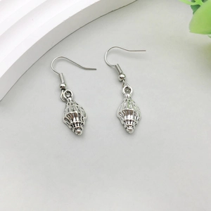 Detailed view of silver sea shell earrings with hooks on a minimalist gray background