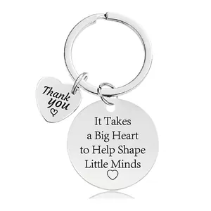Macro detail of engraved steel keychain with inspirational quote for teacher appreciation