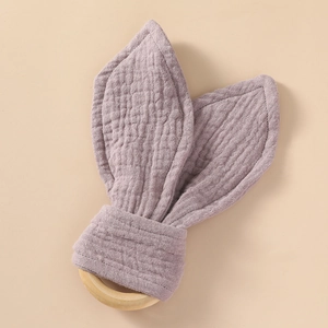 Detailed texture of cotton muslin bunny ear teether with natural wooden ring for infants
