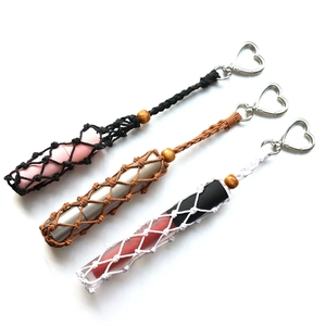 Detail of handmade macrame lipstick holder with heart keychain and wooden beads