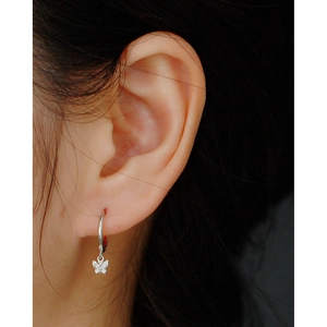 Close-up of a sterling silver butterfly hoop earring featuring sparkling zircons