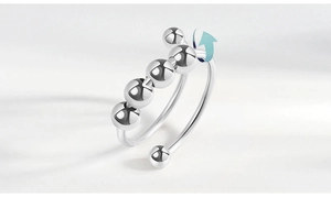 Detail view of rotatable silver beads on adjustable stress relief ring for anxiety