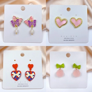 Detail of S925 silver needle earring set featuring enamel heart and rose patterns