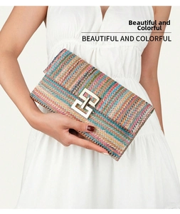 Close-up of a colorful woven clutch bag featuring a prominent gold geometric buckle
