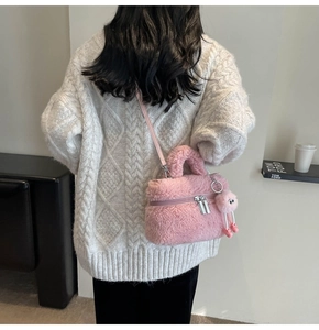 Pink lamb wool crossbody bag shown on a model wearing a white sweater from behind