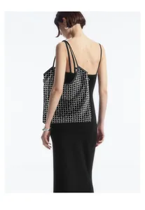 Detailed back view of a black rhinestone mesh tote bag worn on a shoulder