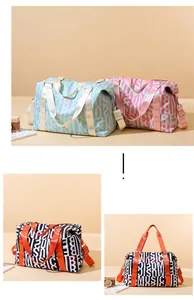 Close-up detail of large capacity travel bags featuring letter prints and adjustable straps