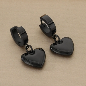 Detail view of black stainless steel hoop earrings with polished hollow heart pendants
