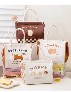 Detail of insulated lunch bags with cotton rope handles and cute cartoon patterns