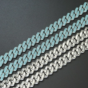 Detailed close-up of hip hop cuban link chains with silver metal and light blue rhinestones