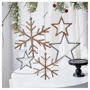 Close-up of glittery champagne gold and silver Christmas star and snowflake ornaments