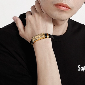Détail du bracelet en silicone noir pour hommes avec plaque dorée et motifs de runes