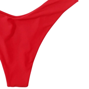 Close-up of bright red low-rise bikini bottom with high-cut design and fine stitching