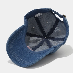 Detail of adjustable metal buckle and inner structure on a denim cotton baseball cap