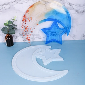 Detail of star and moon resin silicone mold with finished gold and blue gradient tray