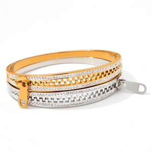 Detail of creative zipper bangle with sparkling crystals in gold and silver finish