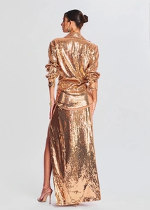 Sparkly rose gold sequin two-piece set featuring long sleeve top and high slit maxi skirt