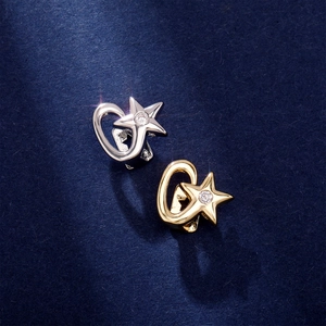 Detail view of gold and silver star-shaped dental grills with sparkling zircon inlays