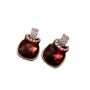 Vintage gold-tone square earrings with deep red gemstones and pavé crystals on white background