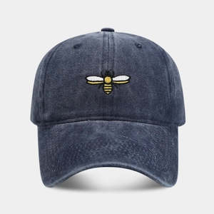 Vintage washed navy blue baseball cap featuring detailed bee embroidery on the front