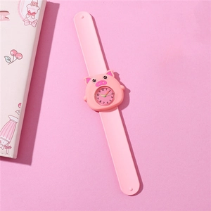 Detail showing pink silicone snap band and cute pig-shaped quartz watch dial for kids