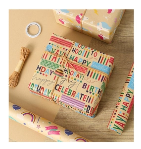 Detail of kraft wrapping paper featuring colorful unicorns, rainbows and Happy Birthday text
