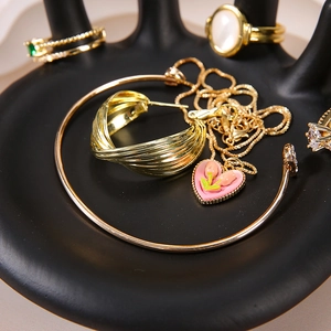 Nordic gold jewelry set on hand-shaped resin display stand for vanity decor