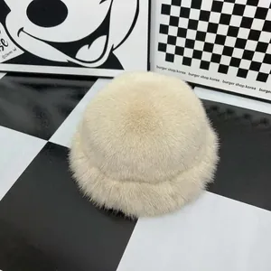 Detail shot of plush off-white faux fur texture on a thick winter bucket hat