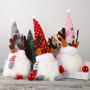 Detail of Christmas glowing gnomes with antlers and plush hats in a cozy holiday scene